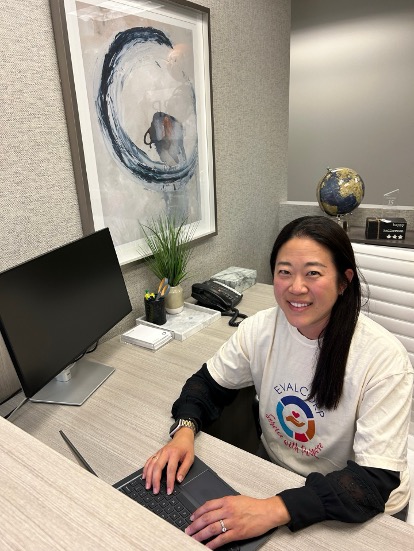 Image of staff member at computer volunteering by designing survey tools.